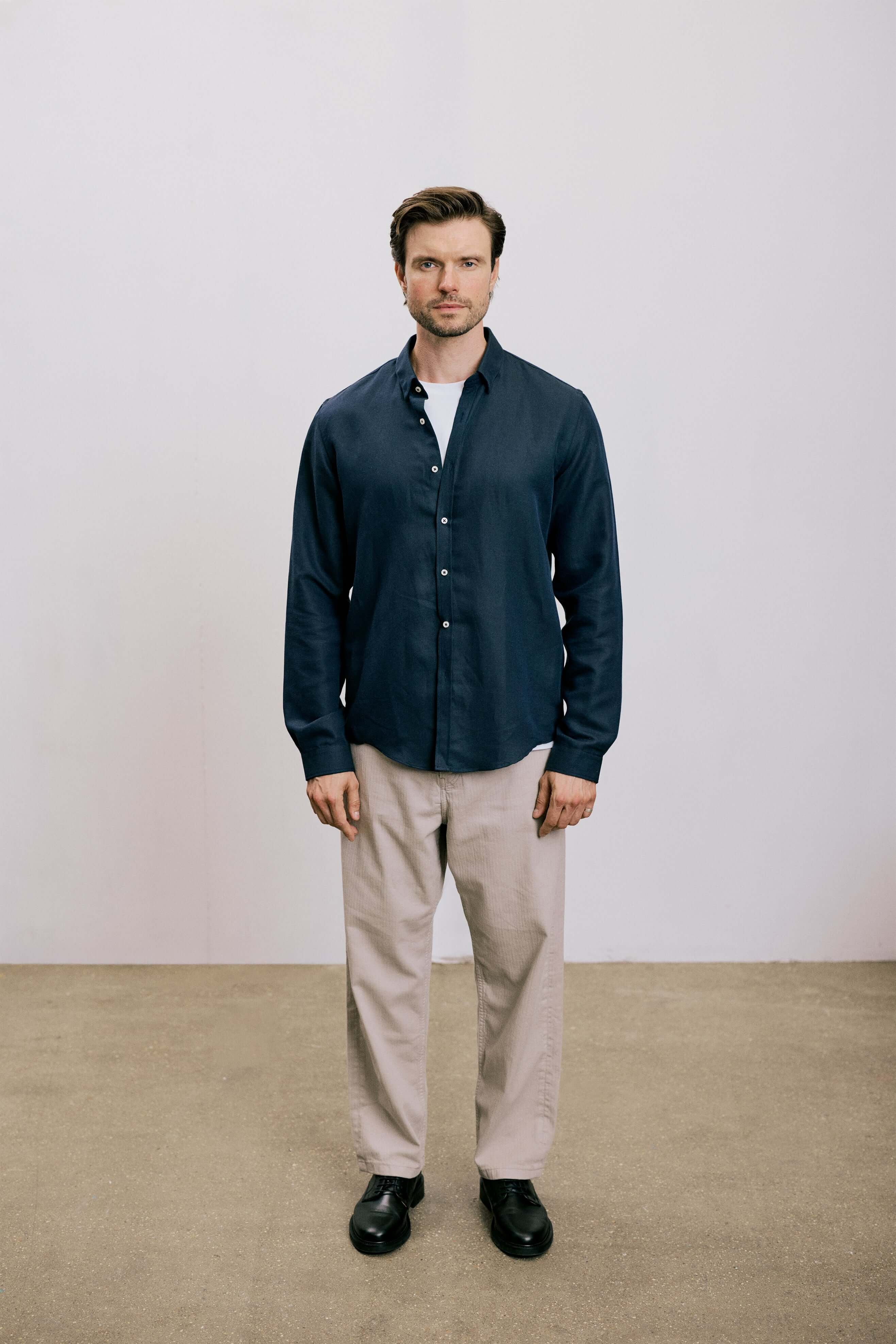 VARRO Evelyn Midnight Navy shirt in relaxed fit, featuring a hidden button-down collar, front view, worn with light pants.