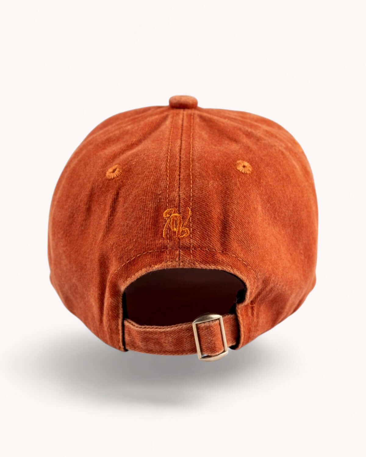 Rear shot of Ember Orange cap with metal strap adjuster