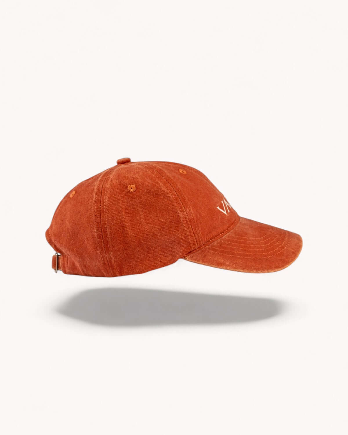 Right side profile of Ember Orange cap showing washed fabric texture