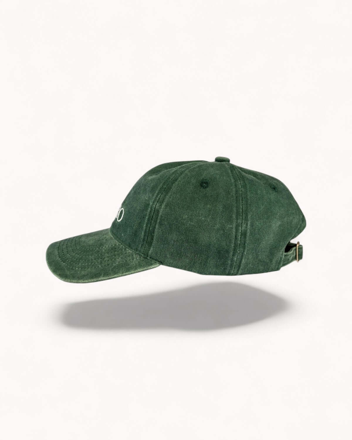 Angled side view of Forest Green cap with faded texture