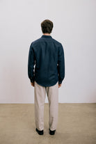 Back view of a man wearing the VARRO Evelyn Midnight Navy shirt in hemp cotton merino blend with relaxed fit and hidden button-down collar.