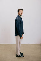 Side view of a man wearing the VARRO Evelyn Midnight Navy shirt with a hidden button-down collar and relaxed fit.