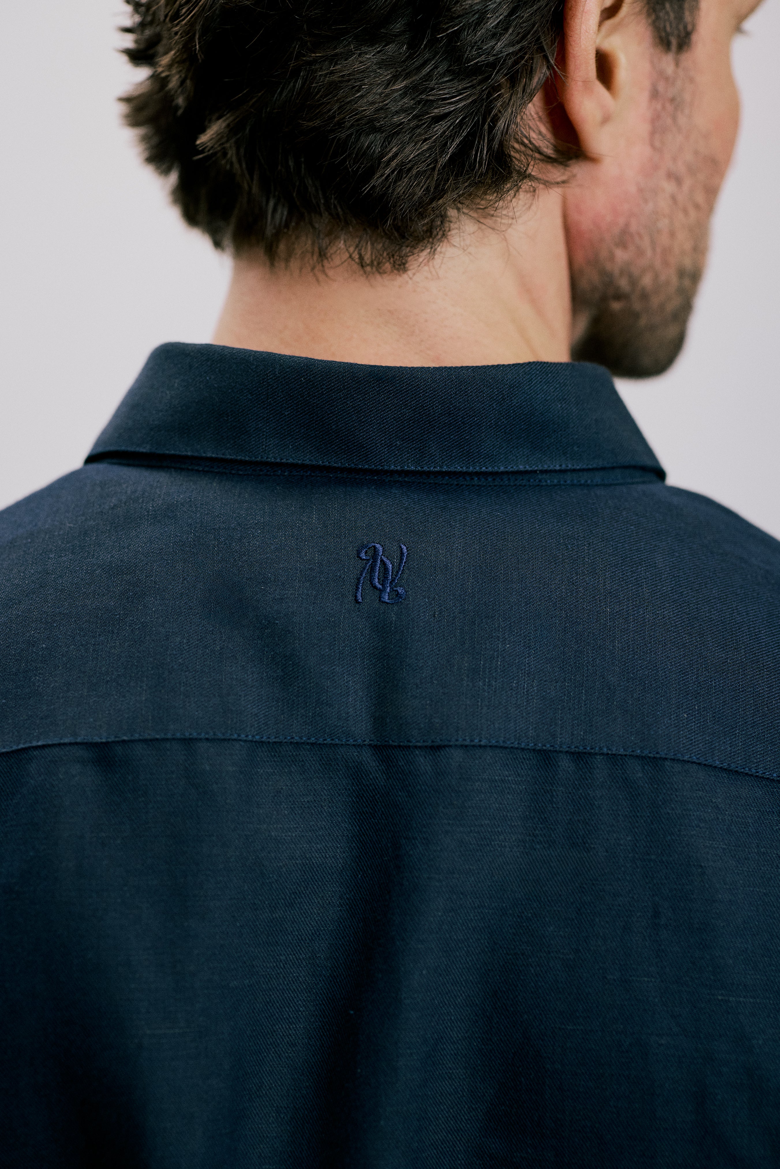Back view of the VARRO Evelyn Midnight Navy shirt showcasing the hidden button-down collar and cuff details.