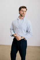 VARRO Evelyn Mist Blue shirt on a model in relaxed fit, showcasing hemp cotton merino blend, hidden button-down collar, long sleeve.