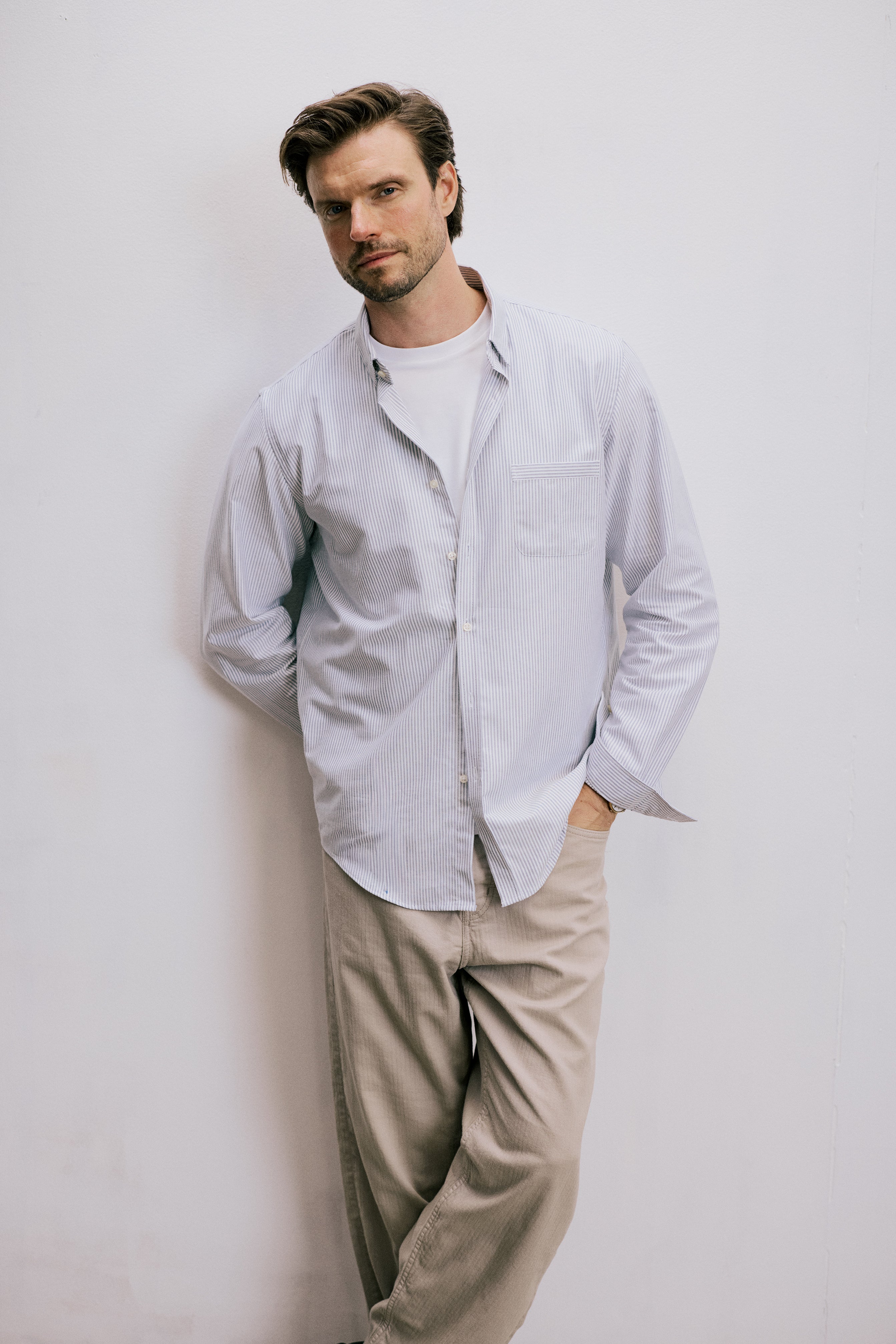 VARRO Keble Navy Stripe Oxford Shirt — relaxed fit, long sleeve, hidden button-down collar, styled with beige trousers.
