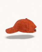 Left side profile of Ember Orange cap showing washed fabric texture